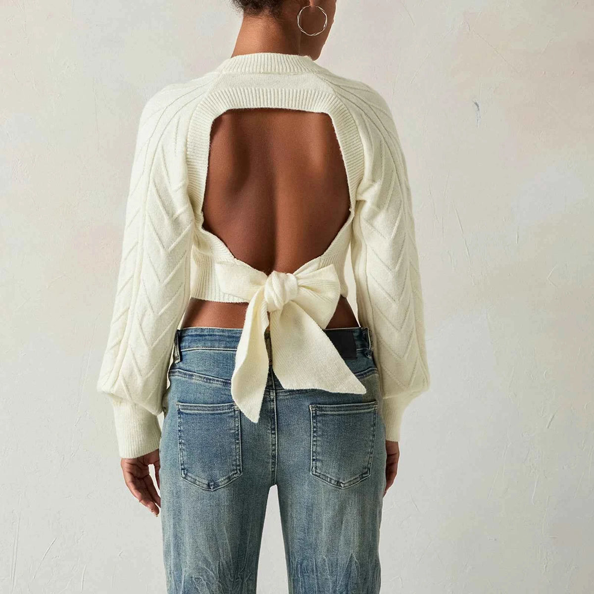 White women's cable-knit sweater with short sleeves, stylish and cozy top from Corporación Turística.