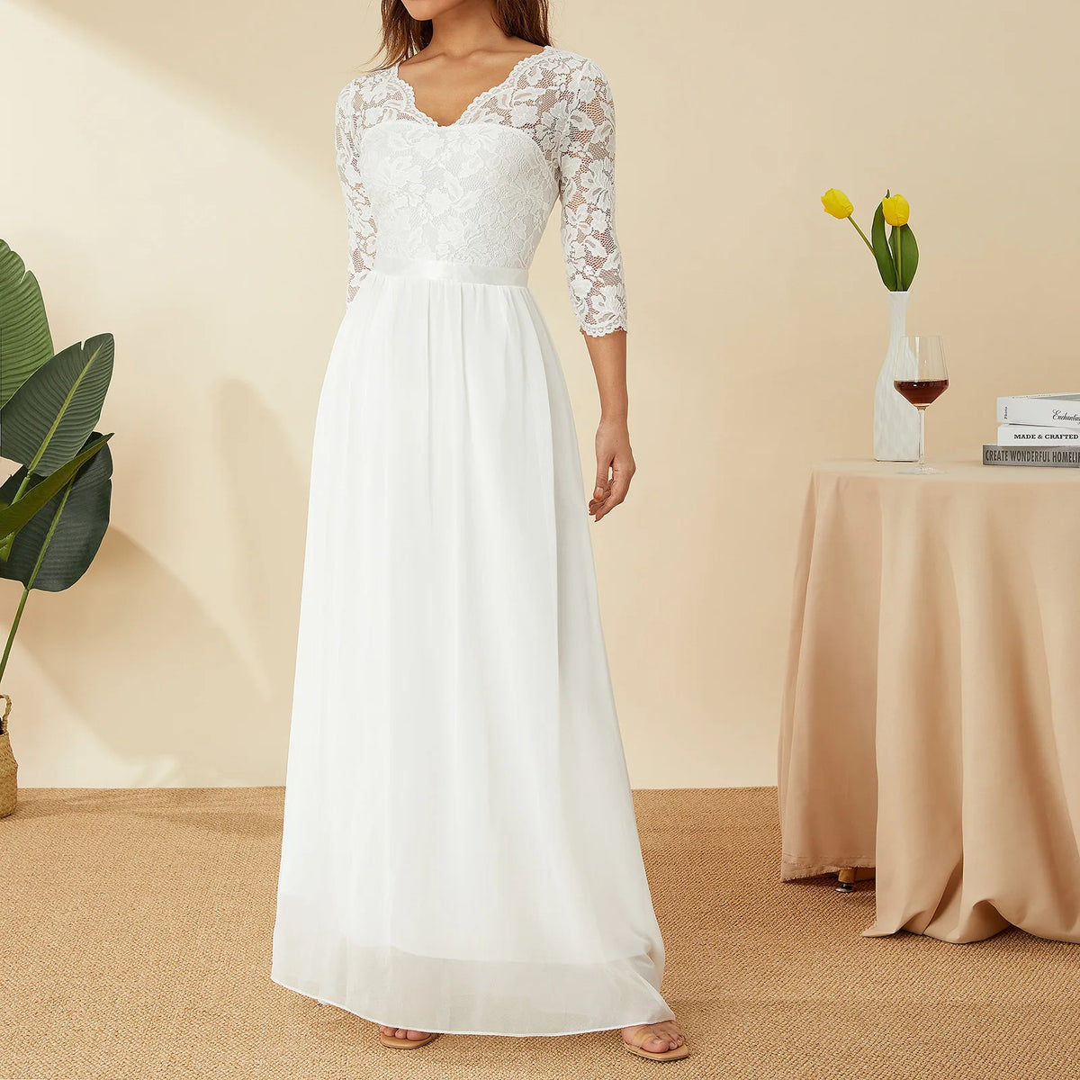Elegant white long gown by Corporación Turística featuring lace and chiffon fabric, perfect for formal occasions.