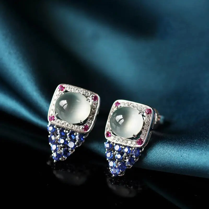 Red round calcedonia earrings with natural ice-hued oval stones, featuring a sleek, elegant design.