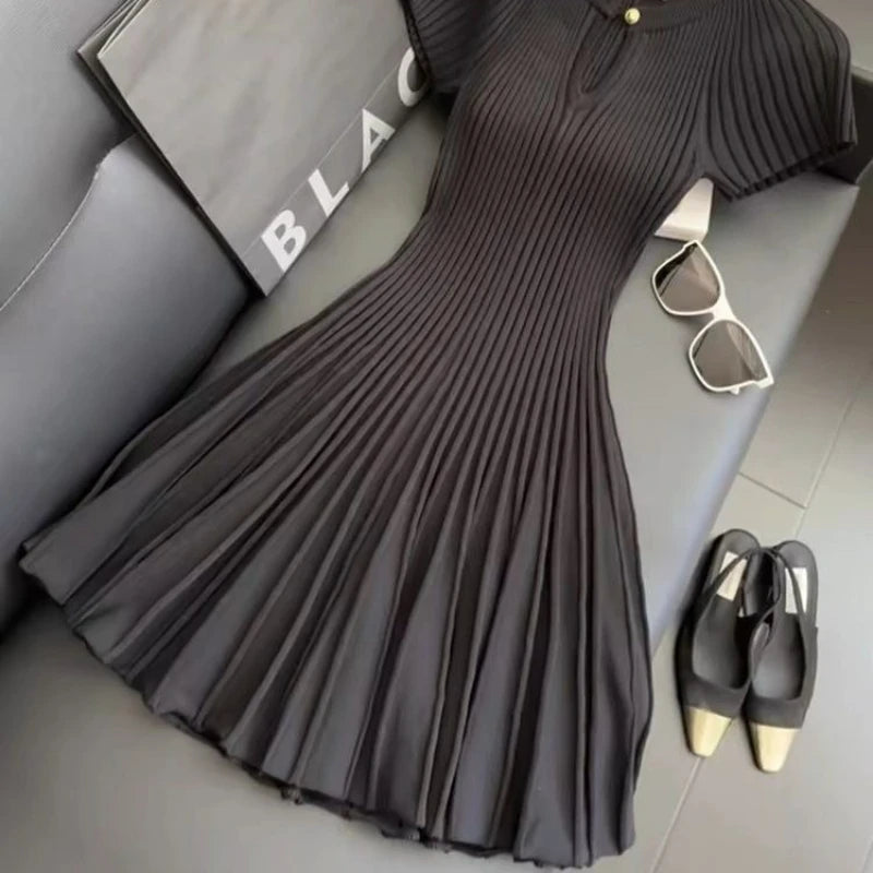 Black knit dress by Corporación Turística featuring an elegant, fashionable style, shown in a white XL size.