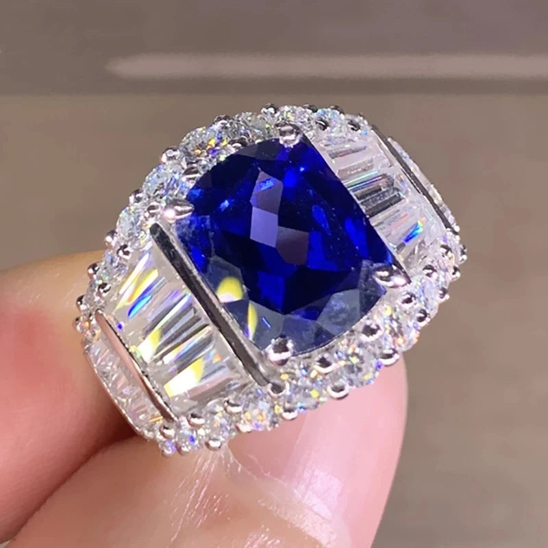 Elegant blue topaz cocktail ring by Butterfly featuring a detailed butterfly design, set in a luxurious band.