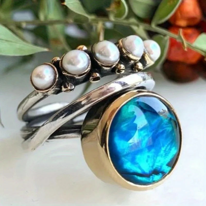 Elegant blue topaz cocktail ring featuring a butterfly design by Corporación Turística, showcasing intricate silver detailing.