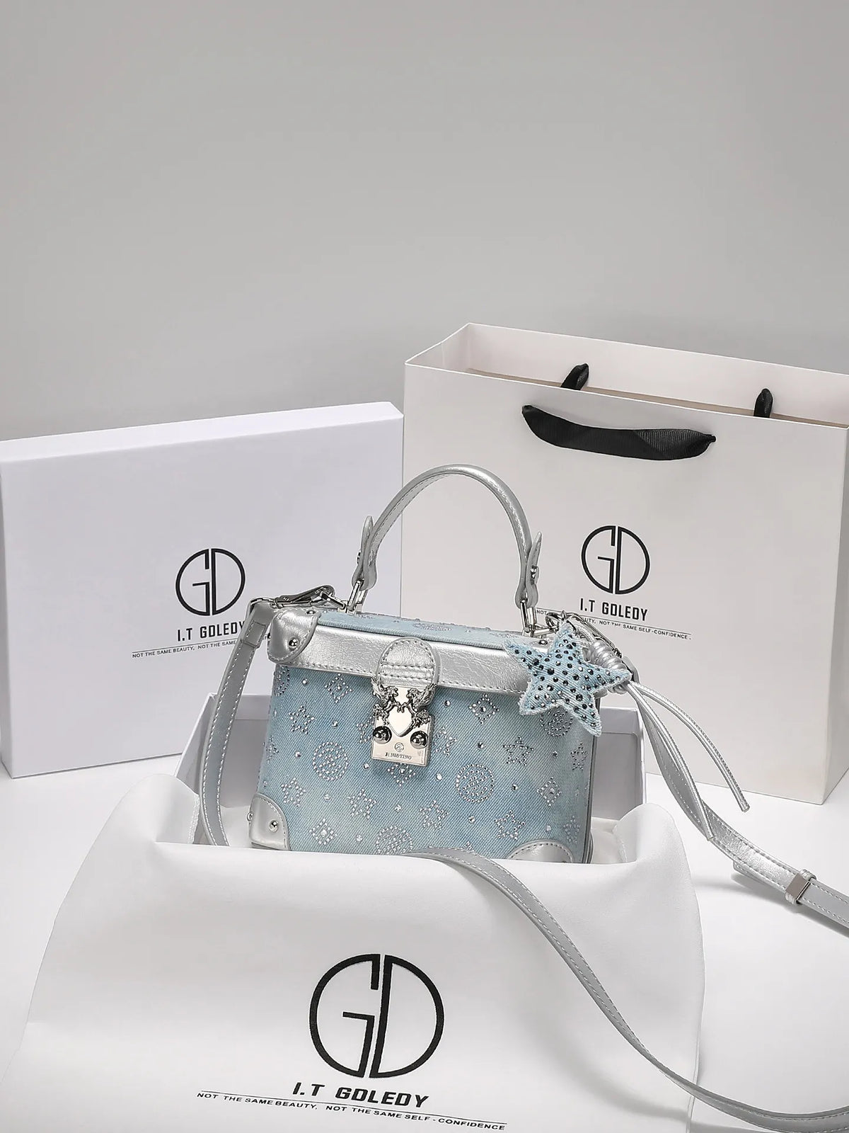 Blue luxury handbag with delicate pendant, stylish and popular, crafted by Corporación Turística for elegant hand carry.
