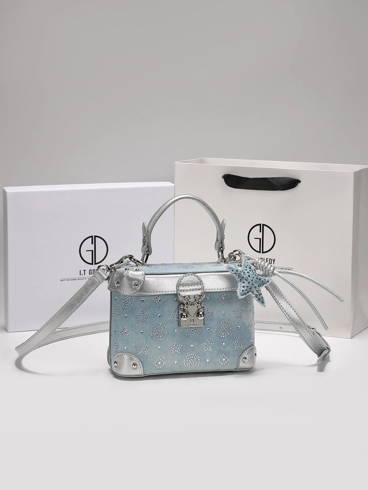 Luxury popular handbag with delicate pendant from Corporación Turística, featuring a stylish blue design and elegant details.