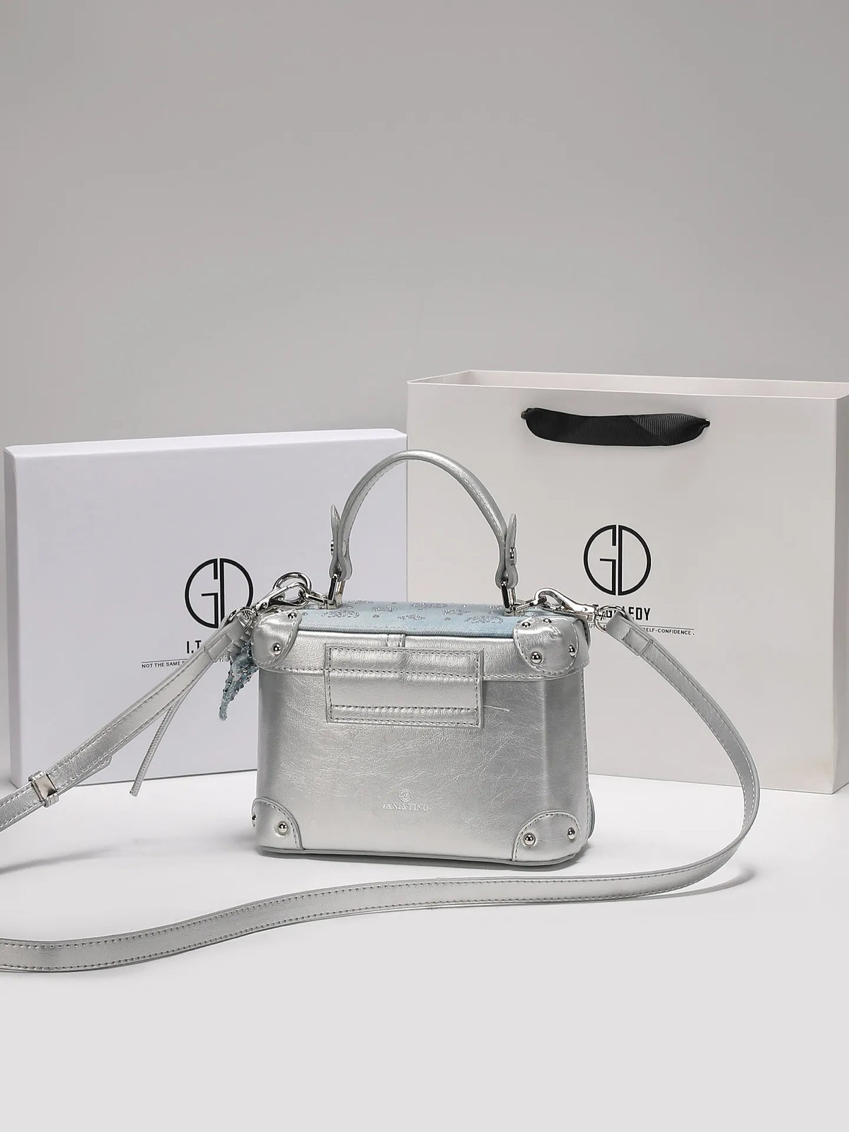 Luxury popular handbag with delicate pendant, in blue leather, featuring elegant design and stylish gold accents.
