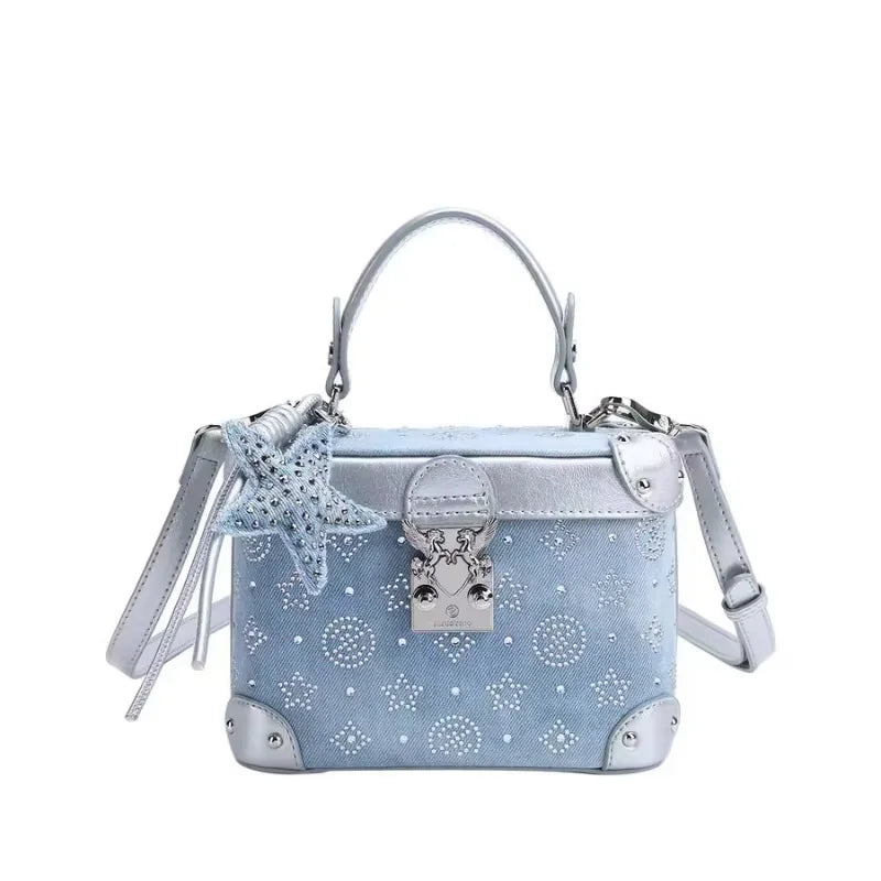 Luxury popular hand clutch bag with delicate pendant by Corporación Turística, in elegant blue color.