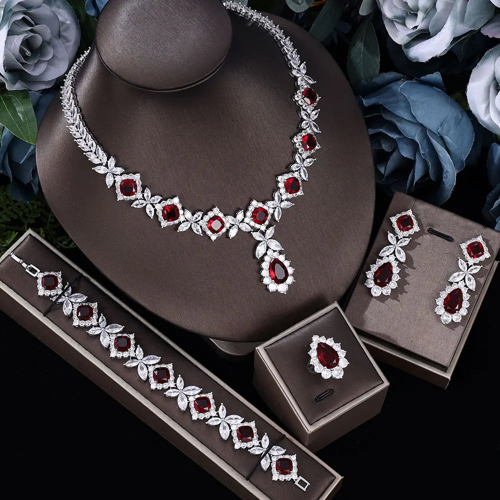 Blue and red wedding jewelry set with zircon stones, featuring earrings and necklace, in a 2024 collection by Corporación Turística.
