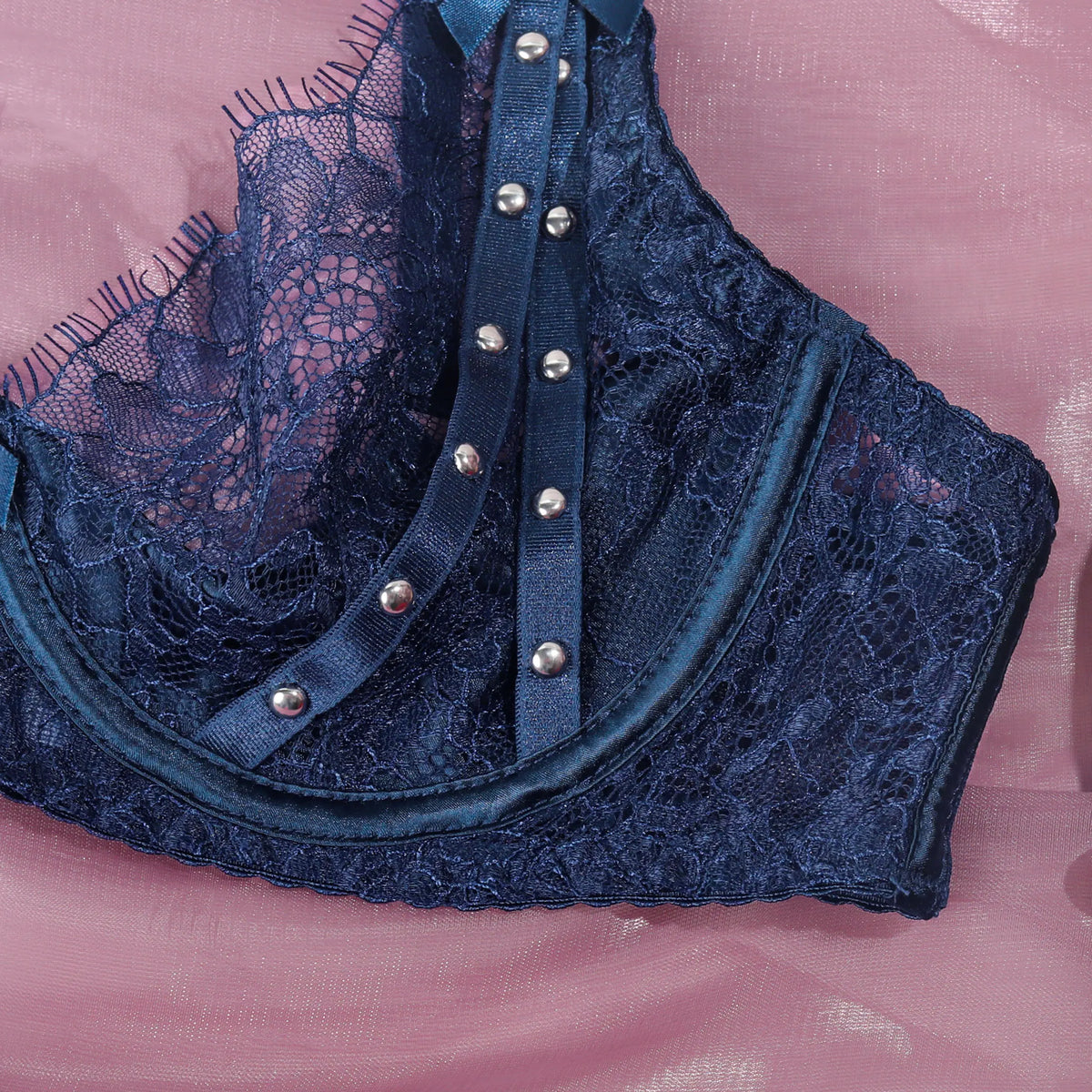 Luxury women's lingerie set featuring a blue lace bra and matching underwear from Corporación Turística.