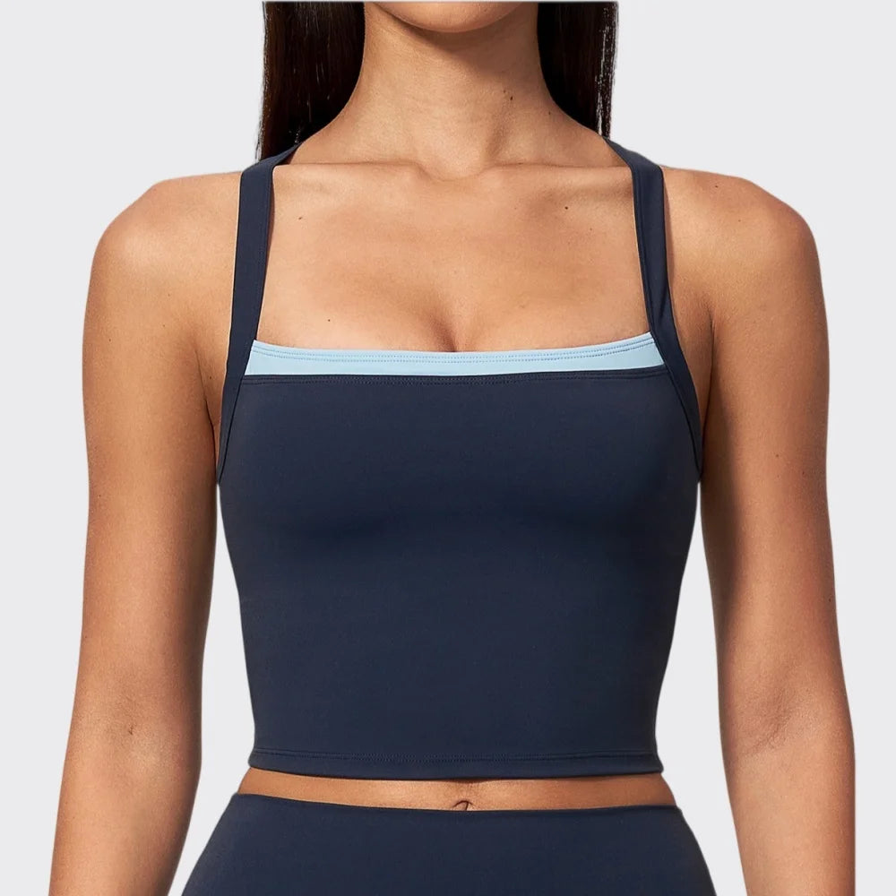 Blue women's sports bra, two-piece design by Corporación Turística, featuring sporty fit and supportive fabric.