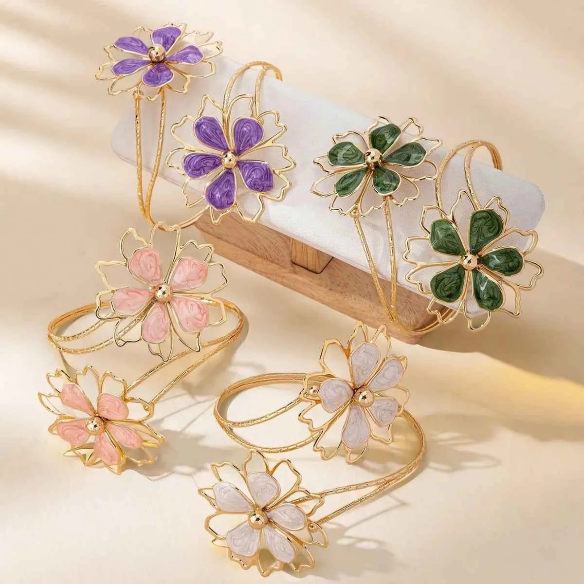Open multicolored floral bracelet by Corporación Turística featuring hollow flower designs and vibrant colors.