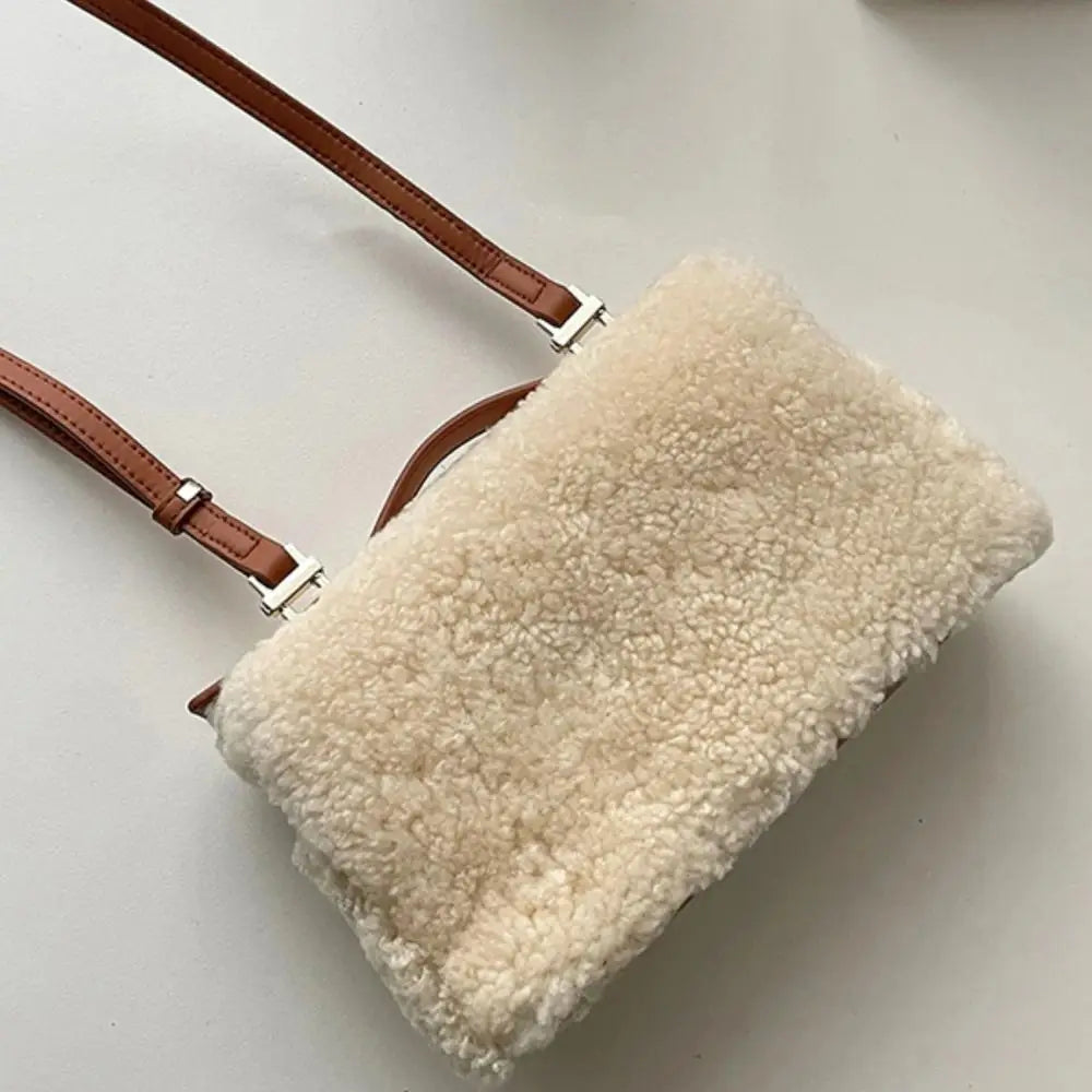 Brown fashion velvet leather clutch bag with top handle and sleek design, made by Corporación Turística.