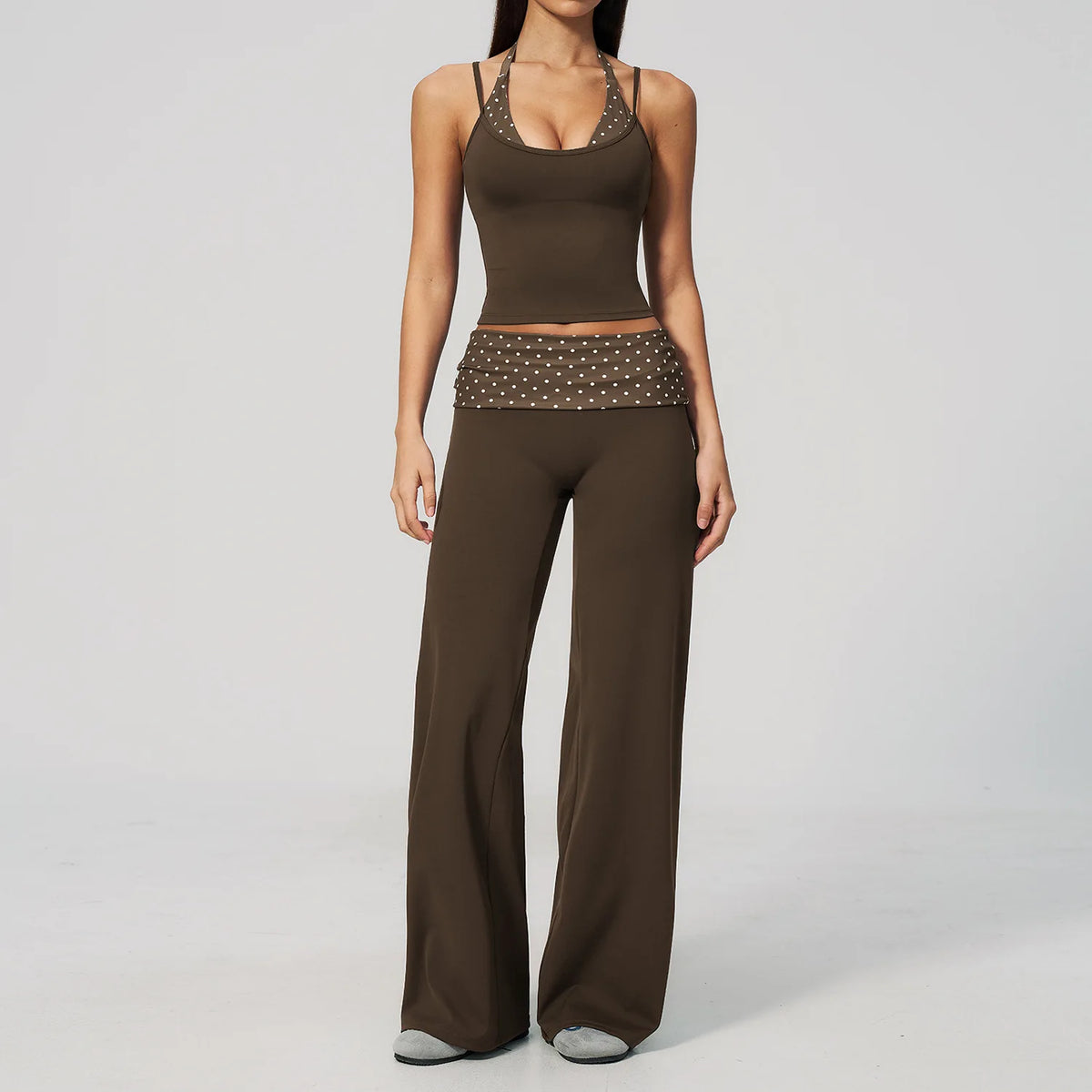 Brown dotted 2-piece yoga set for women by Corporación Turística, including a sports top and leggings, on a white background.