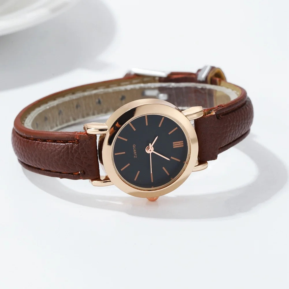 Minimalist white dial women's quartz watch by Corporación Turística with a sleek brown strap.