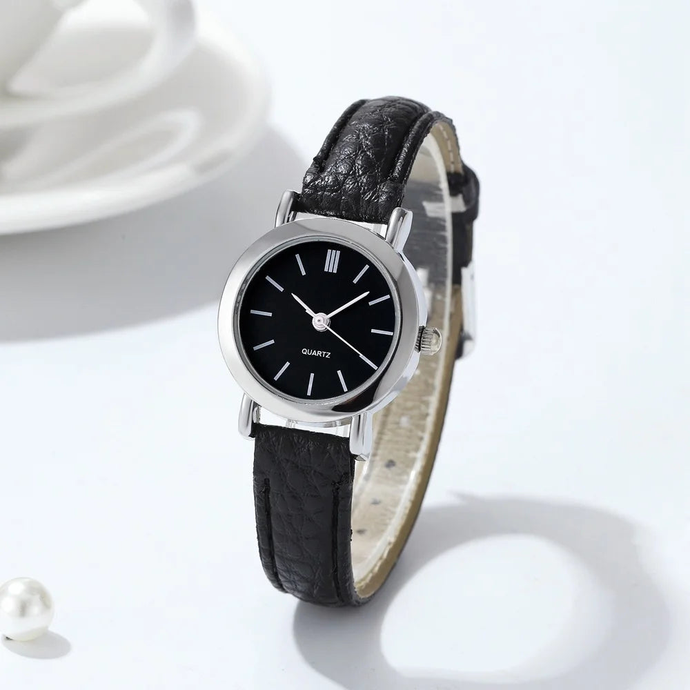 Minimalist women's quartz watch with white dial and brown strap by Corporación Turística, elegant and stylish accessory.