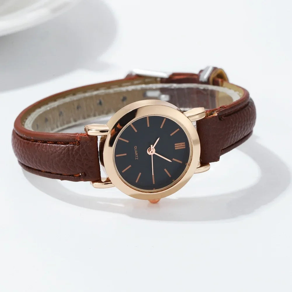Minimalist women's quartz watch with white dial by Corporación Turística, featuring a sleek design and brown strap.