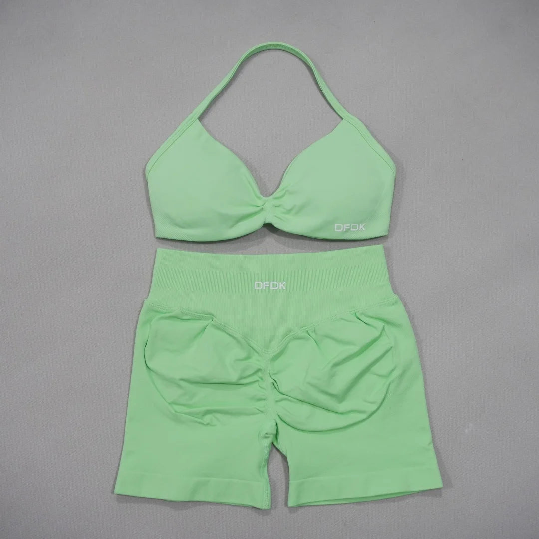 Brown women's 2-piece sports set with bra and shorts from Corporación Turística, made of comfortable athletic fabric.