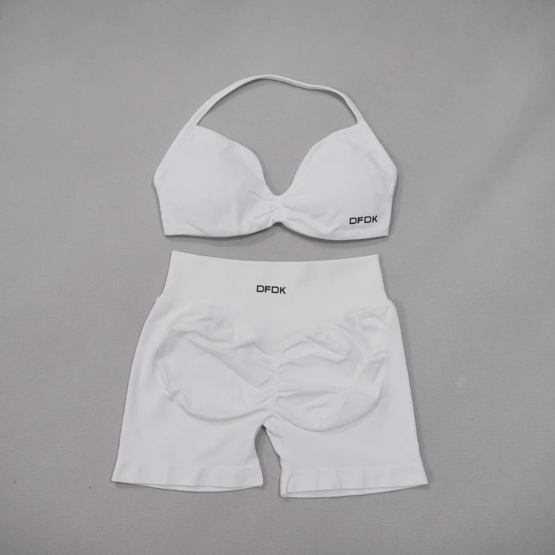 Brown women's 2-piece sports set with DFDK sports bra and leggings, made by Corporación Turística, shown on a white background.