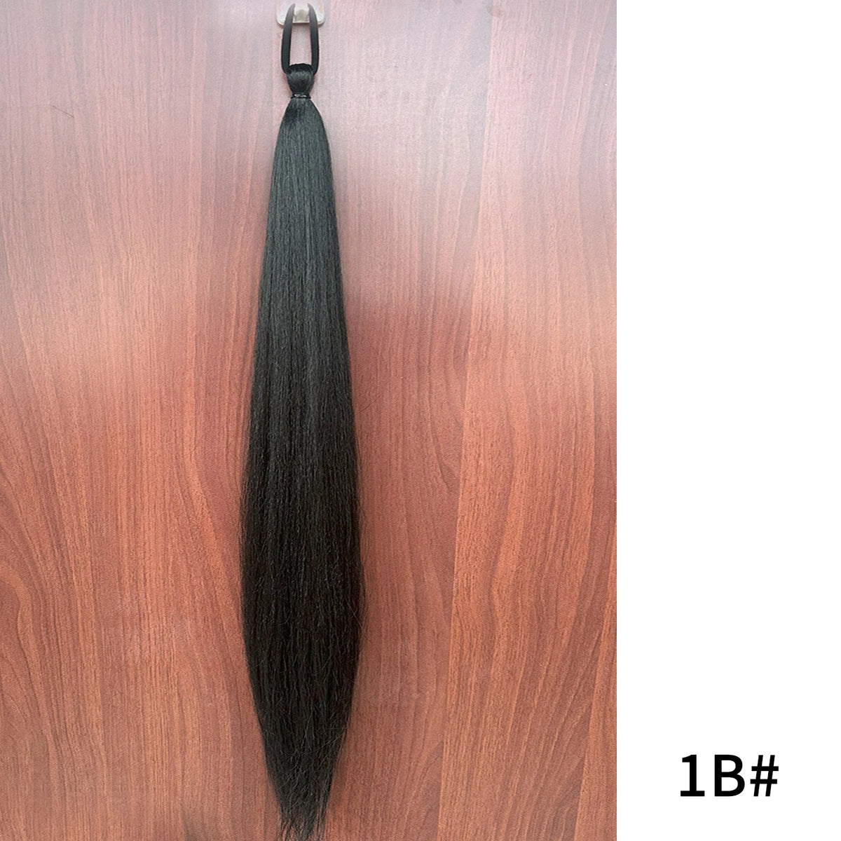 Synthetic purple ponytail extension with band, 26-28 inches long, by Corporación Turística, showing the vibrant hair and band attachment.