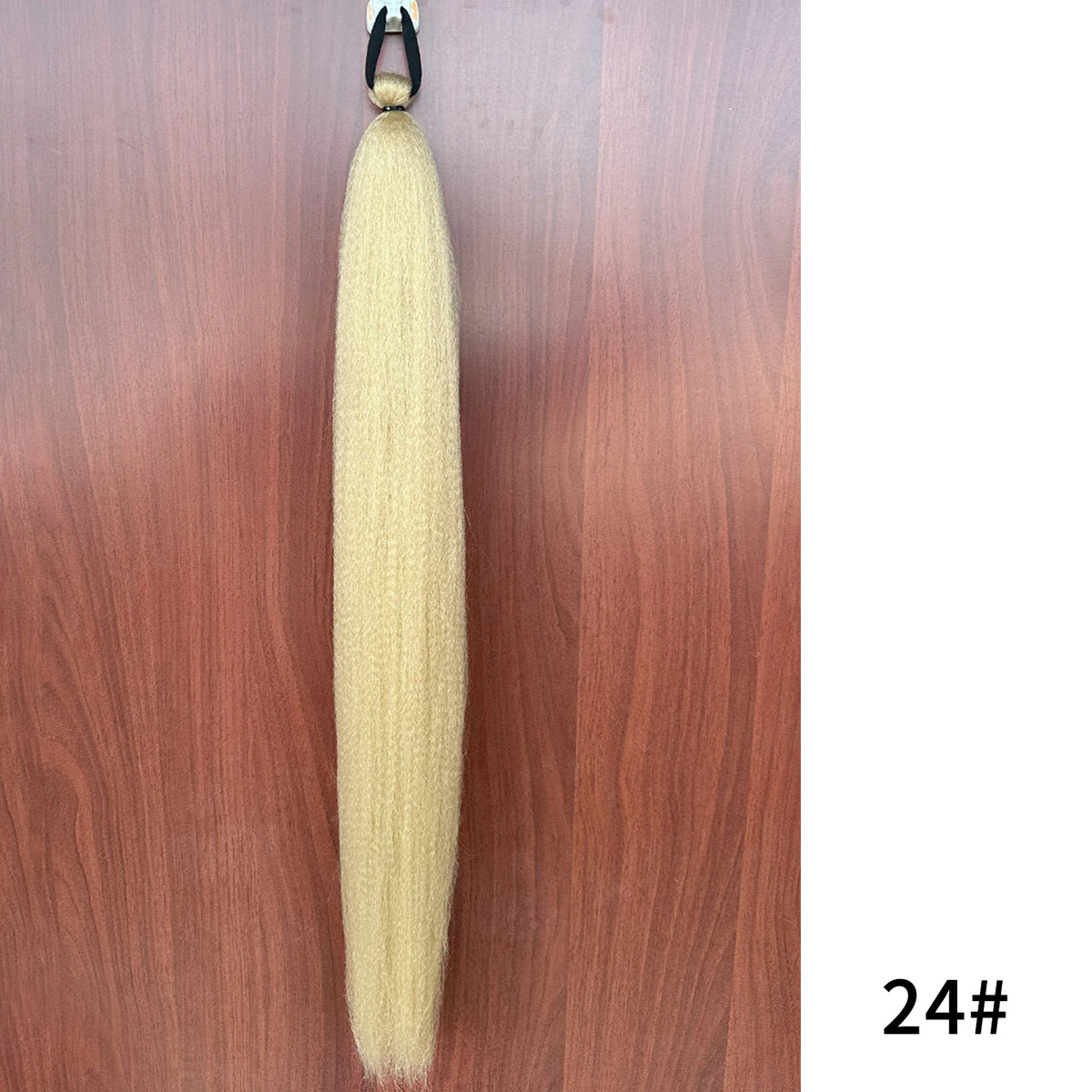 Purple synthetic ponytail extension with band, 26-28 inches long, by Corporación Turística, shown attached for a full hair look.