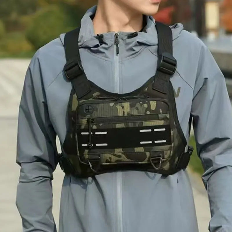Outdoor men's chest bag by Corporación Turística, caqui color with front pocket and adjustable strap for outdoor activities.