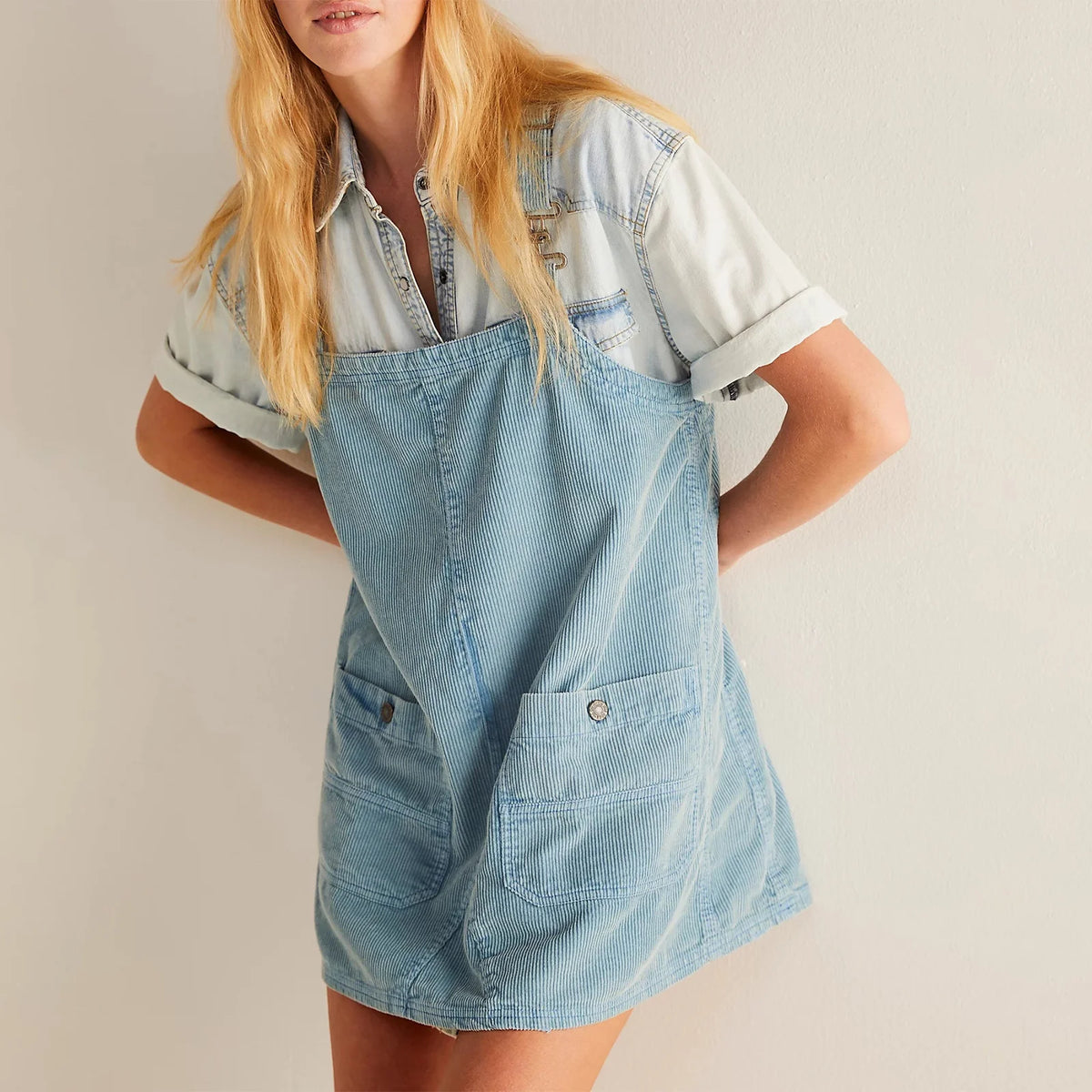 Caqui corduroy women's dress with straight bib front, casual style, by Corporación Turística, shown on a model.
