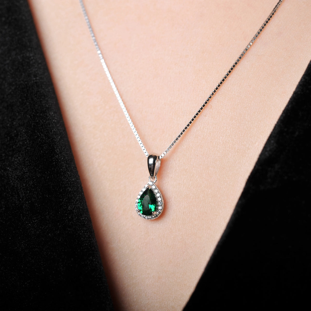 Sterling silver 925 necklace with emerald pendant, showcased with a shiny chain and detailed craftsmanship for elegant jewelry styling.