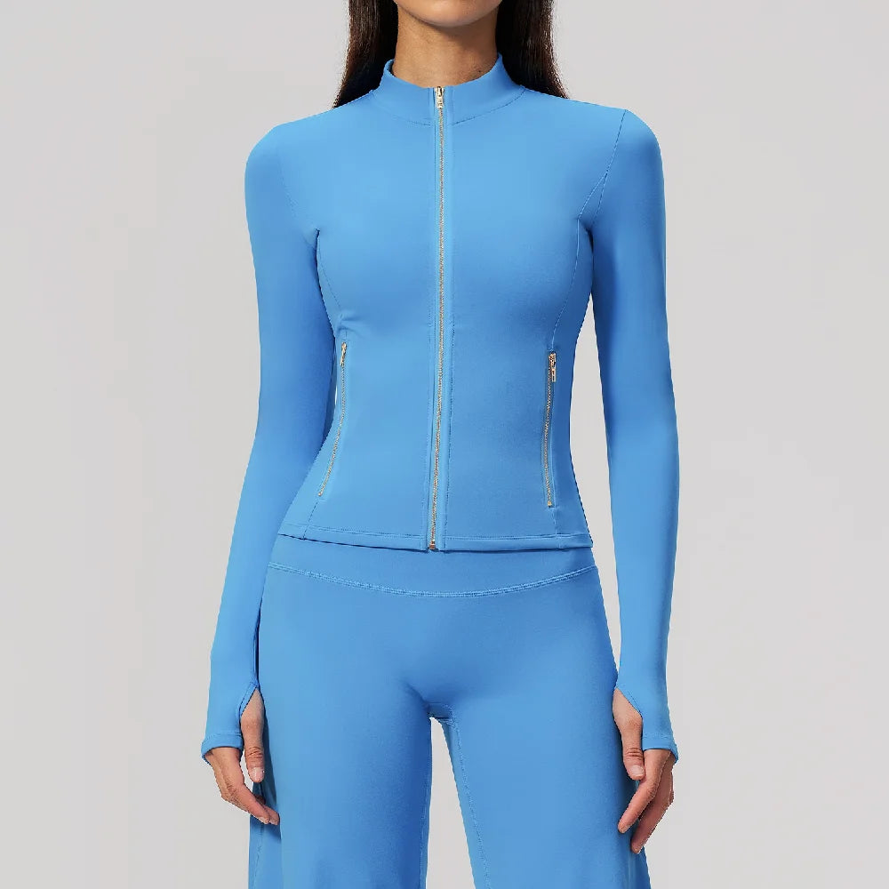 Pink long-sleeve thin athletic shirt with zipper from Corporación Turística, featuring cherry blossom design, suitable for sports or active wear.