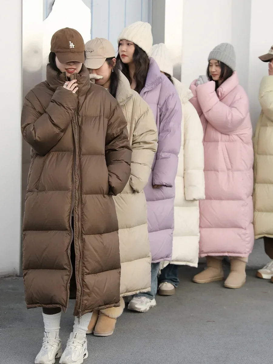 White women's puffer down jacket from CHIC VEN by Corporación Turística, shown hanging on a clothing rack with a clean background.