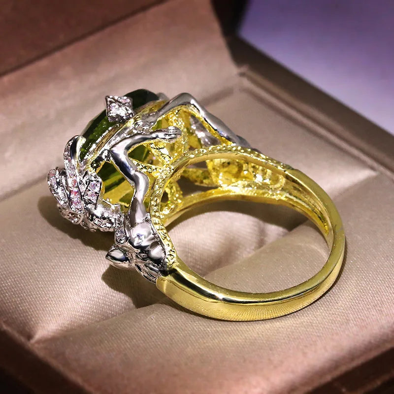 Gold ring with natural emerald gemstones, featuring vibrant green stones set in a polished gold band.