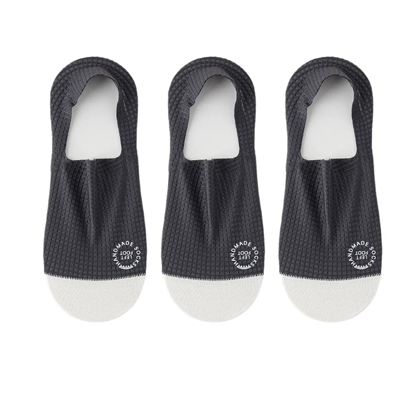 Three pairs of dark grey men's invisible socks from Corporación Turística, suitable for shoe sizes 37-44.