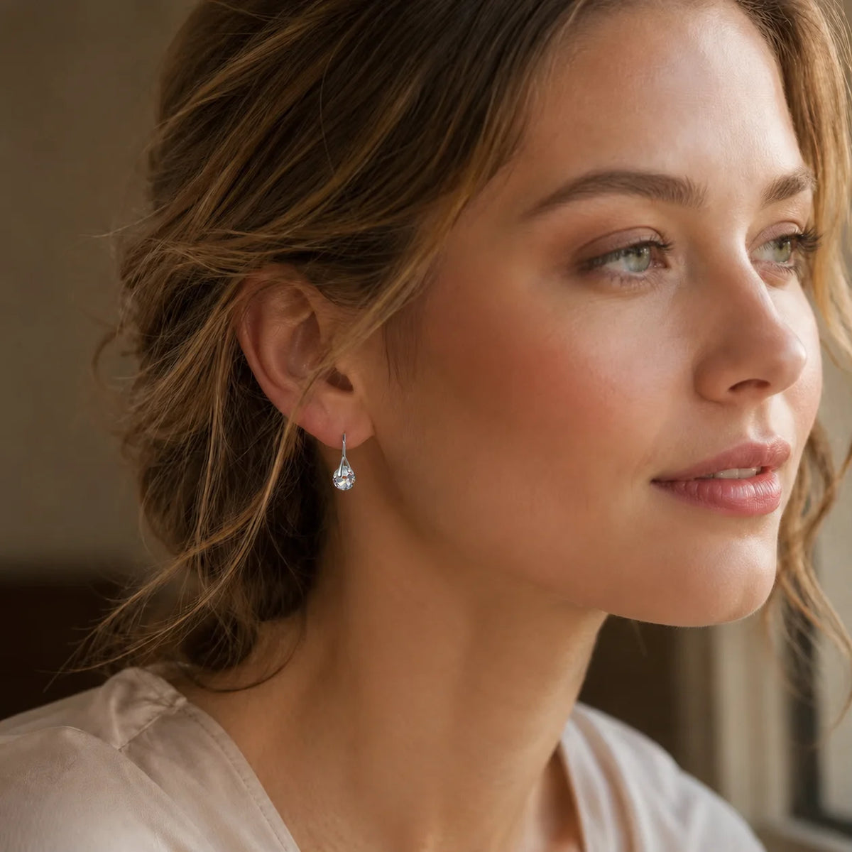 Elegant dangling earrings with round crystal beads from Corporación Turística, showcasing their sparkling, jewelry design.
