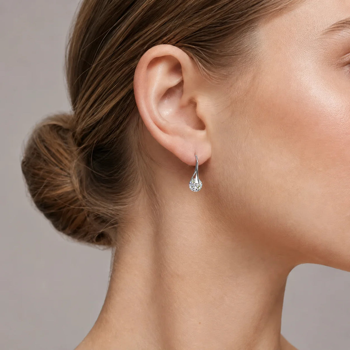 Gold dangling earrings with round crystal beads from Corporación Turística, featuring elegant crystal ball pendant design.