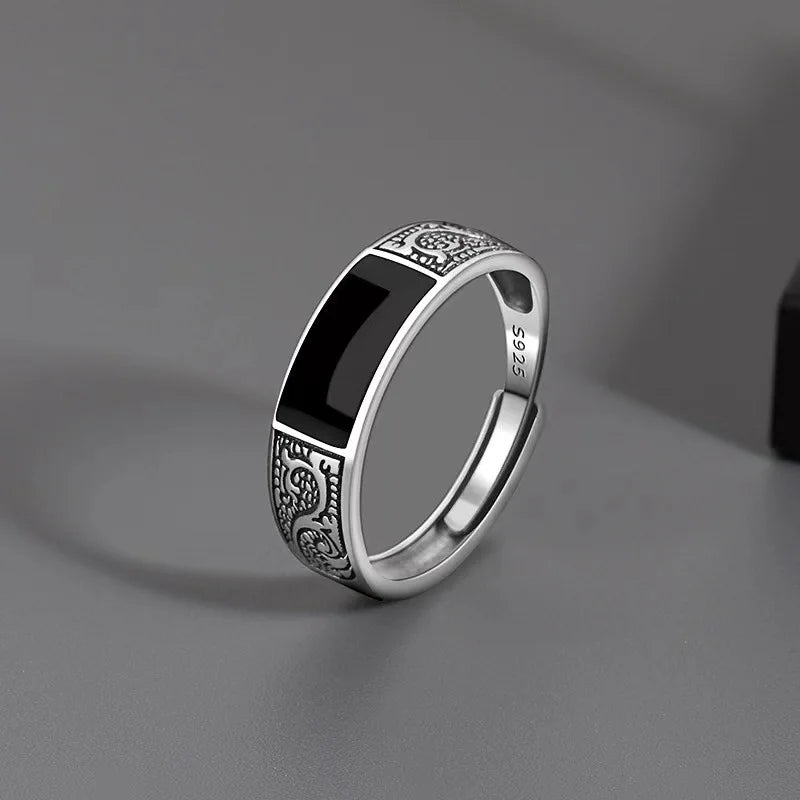 Sterling silver 925 men's ring with a black gemstone, featuring a sleek and modern design for masculine style.