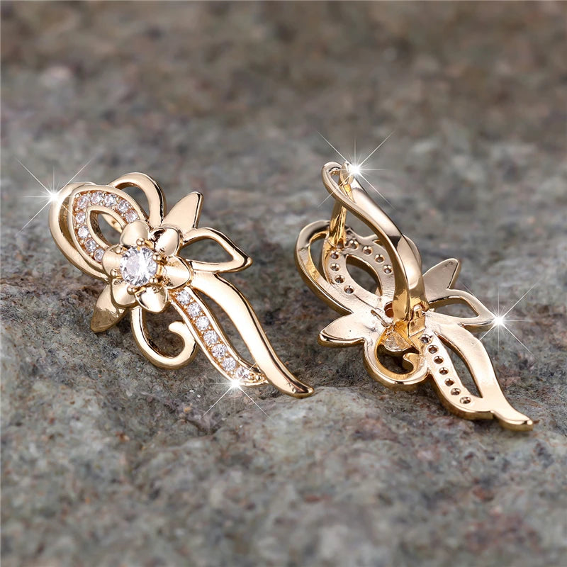 Silver hoop earrings shaped like flowers with sparkling cubic zirconia stones from Corporación Turística.