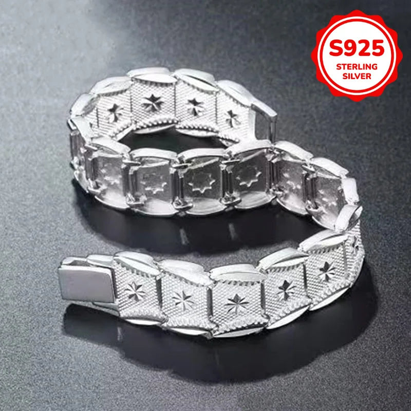 Elegant sterling silver bracelet with coin design, crafted by Corporación Turística, showcasing intricate metalwork and stylish detail.