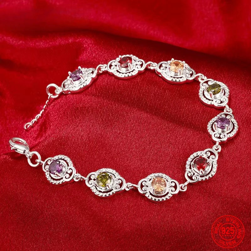 Fine sterling silver bracelet with crystal charms, featuring delicate links and sparkling crystal accents for elegant wristwear.