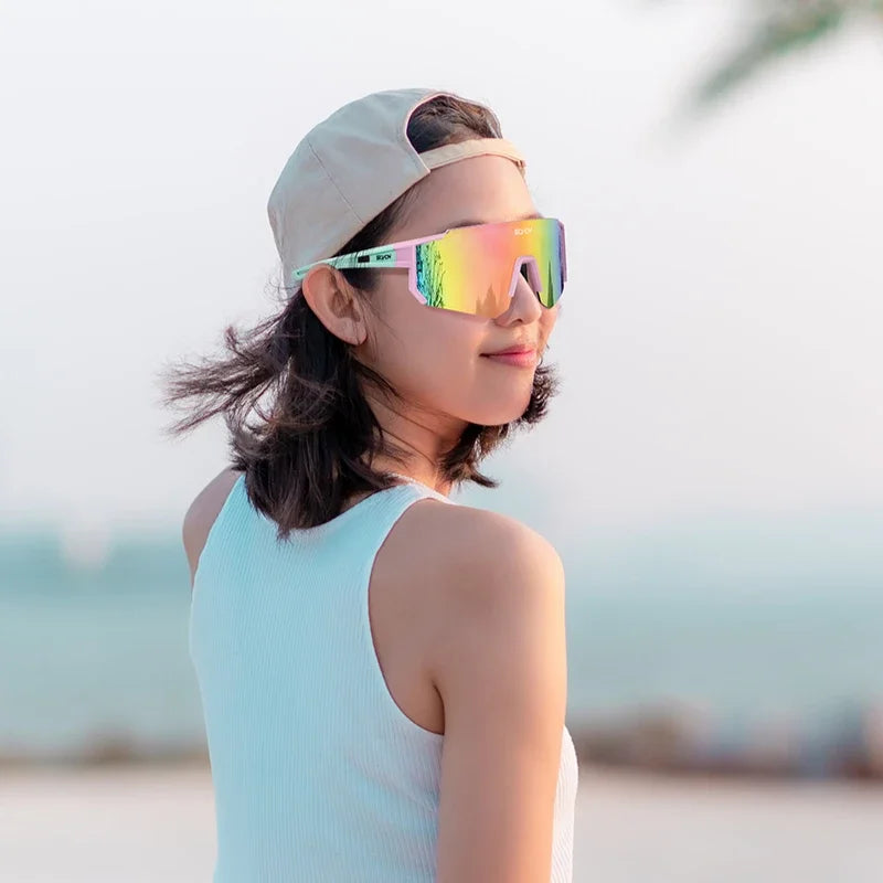 Pair of outdoor cycling sunglasses from Corporación Turística with black frames and tinted lenses for sun protection.