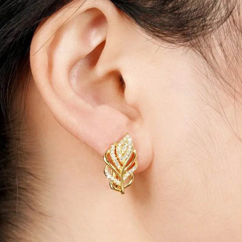 Hoja-shaped hoop earrings by Corporación Turística, featuring elegant leaf design in gold-tone metal.