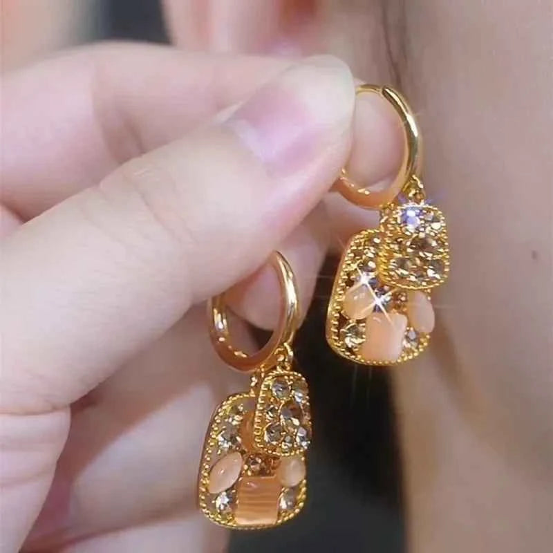 Square crystal zirconia earrings with a warm brown hue, designed by Corporación Turística, featuring elegant geometric style.