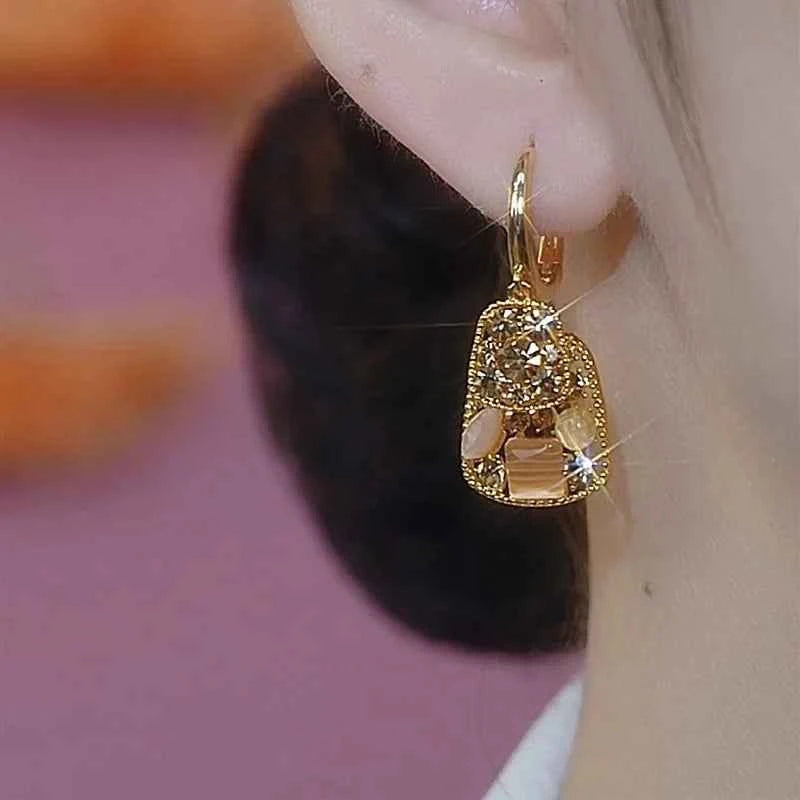 Square crystal zirconia earrings with brown stones from Corporación Turística, showcasing the elegant jewelry design.