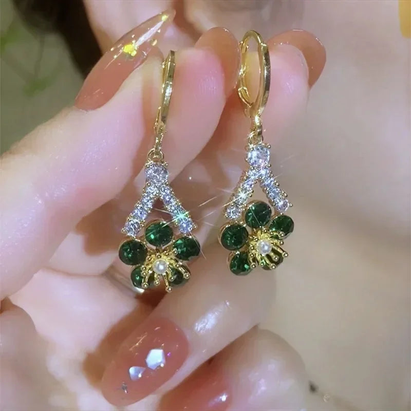 Elegant green crystal flower earrings from Corporación Turística, featuring luxurious floral design and sparkling gemstone details.