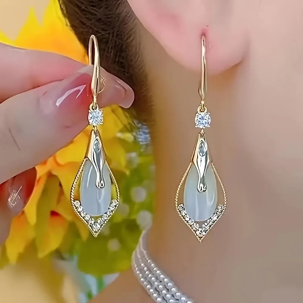 Exquisite cat's eye stone pendant earrings with elegant dangling design from Corporación Turística.