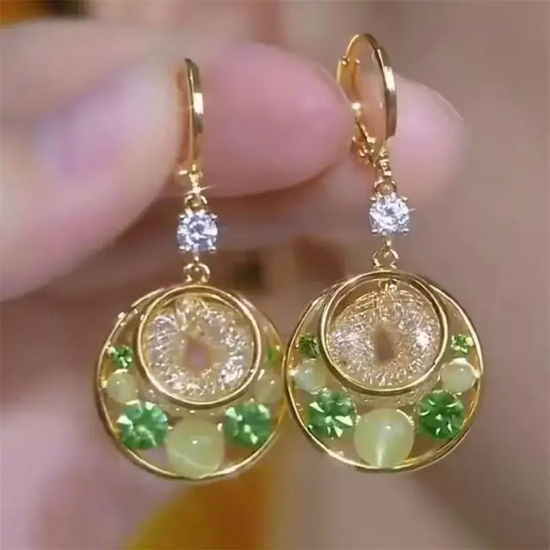 Exquisite cat's eye stone drop earrings by Corporación Turística, featuring elegant hanging design with polished gemstones.