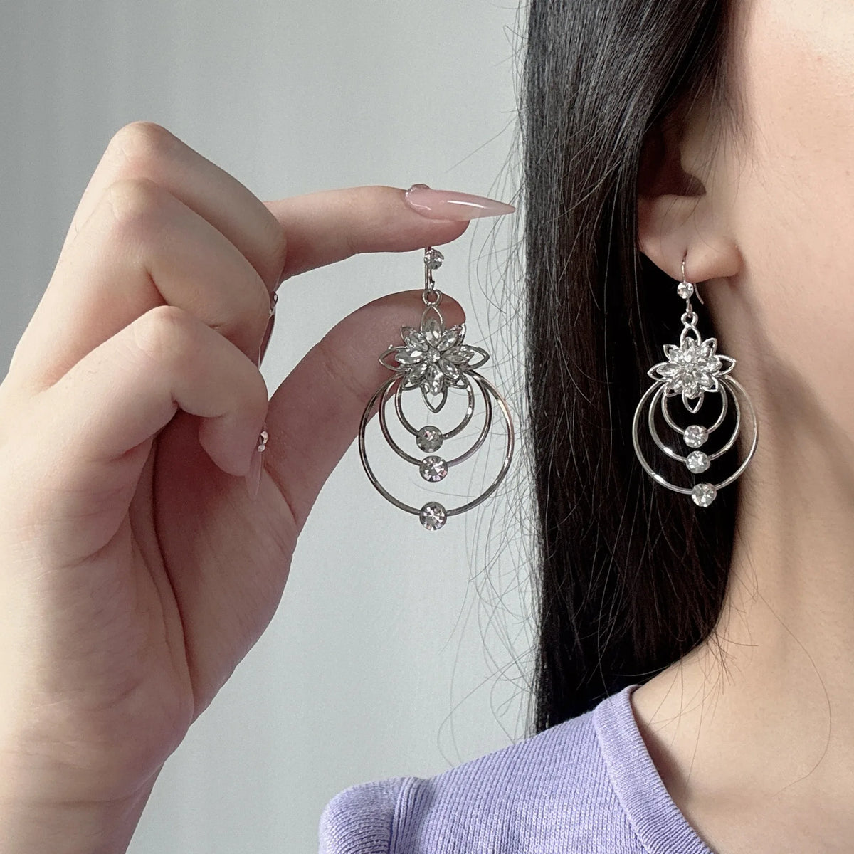 Elegant circular flower earrings from Corporación Turística featuring intricate floral designs and a stylish personal touch.