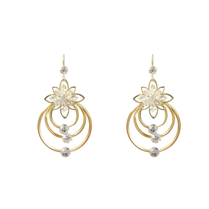 Elegant circular floral earrings by Corporación Turística featuring intricate flower designs and unique personal style.