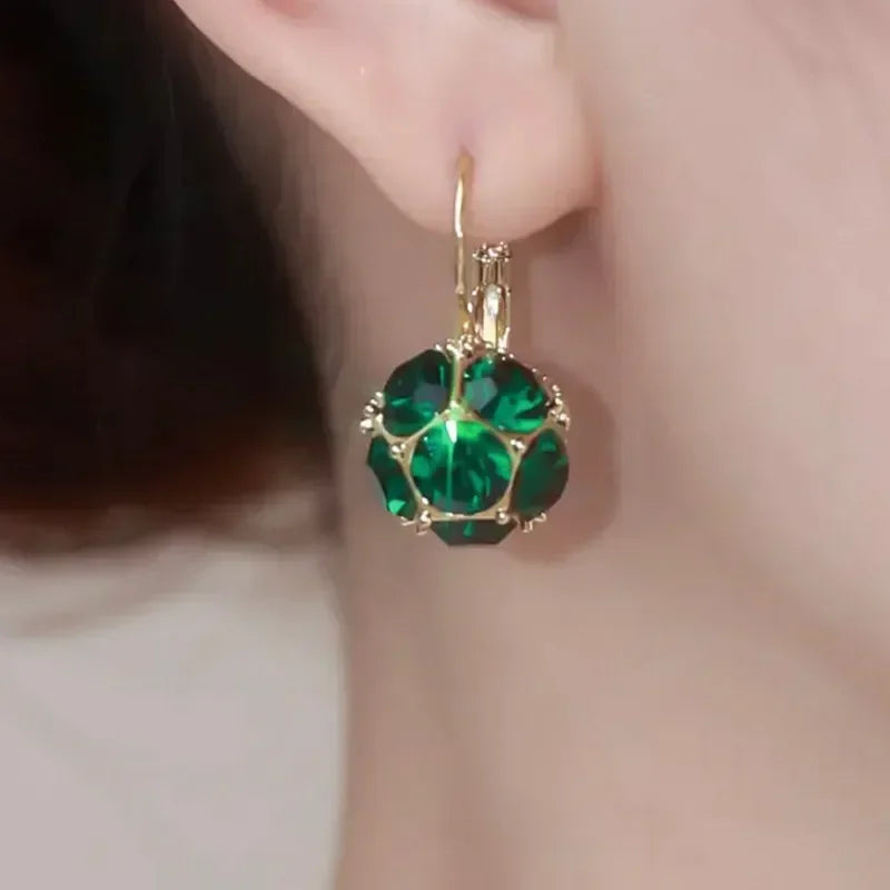 Elegant circular floral earrings by Corporación Turística featuring intricate flower designs for a stylish look.