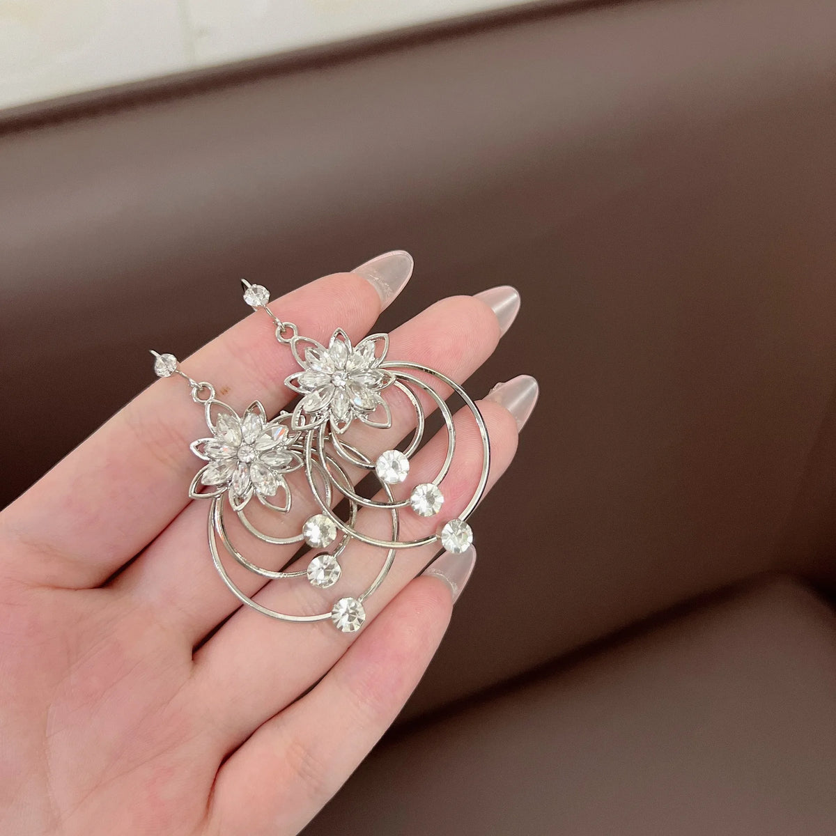 Elegant circular floral earrings from Corporación Turística featuring intricate flower designs, perfect for stylish accessories.