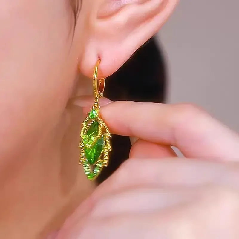 Elegant crystal drop earrings by Corporación Turística featuring intricate circular crystal pendants on silver hooks.
