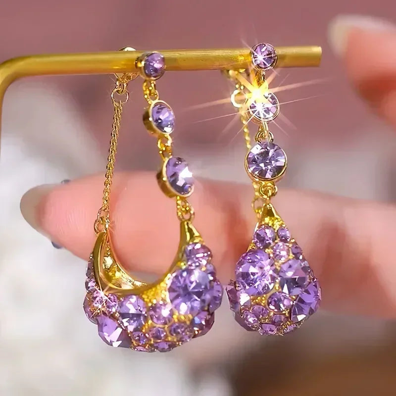 Elegant crystal drop earrings from Corporación Turística featuring shimmering circular crystal pendants.