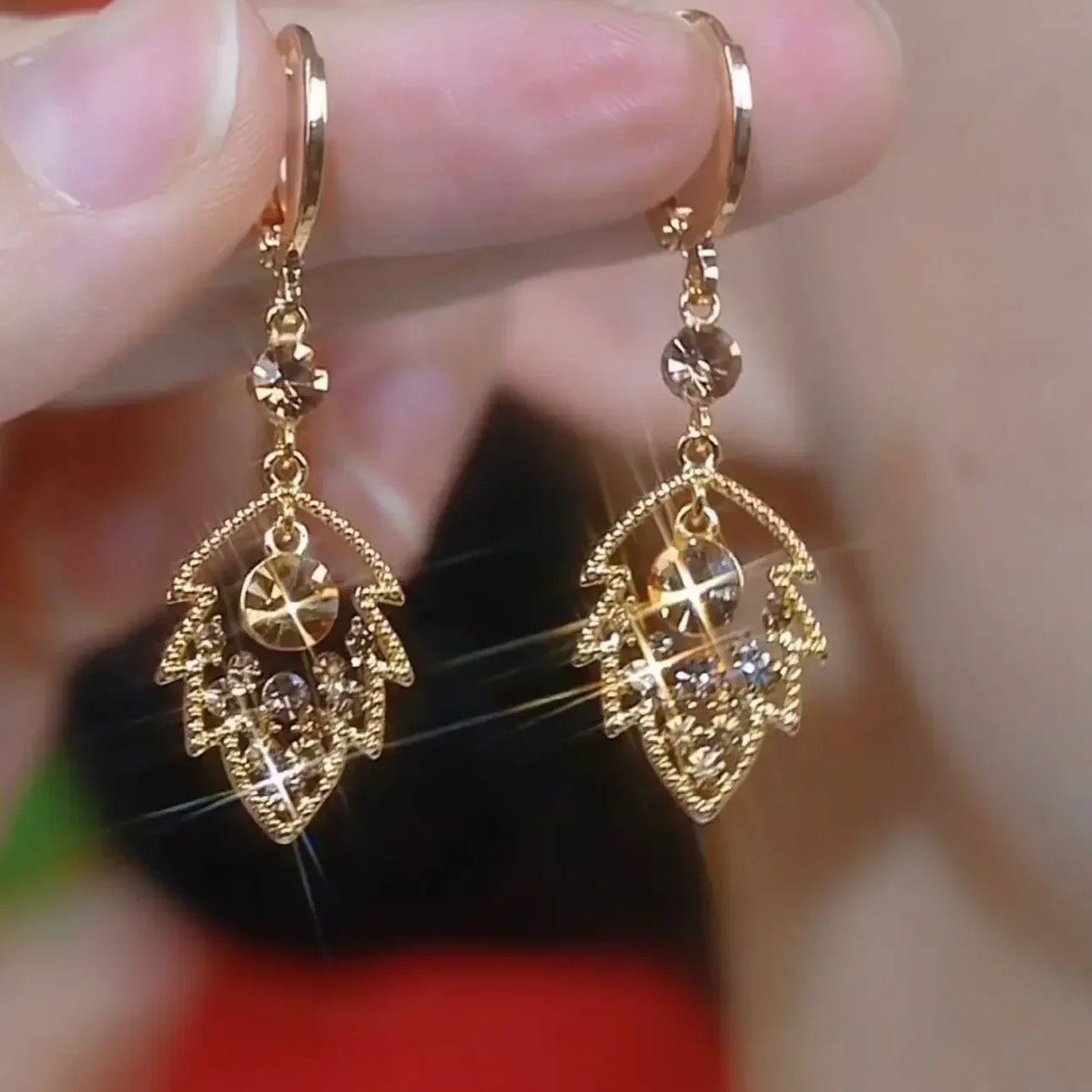 Elegant crystal drop earrings by Corporación Turística featuring intricate circular crystal pendants on silver hooks.